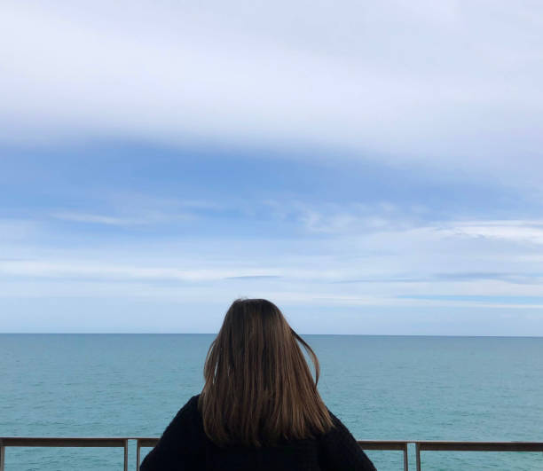 istock Girl watching the sea view 954537934