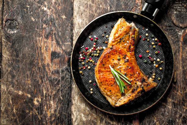 istock Fried slice of pork with spices. 954539268
