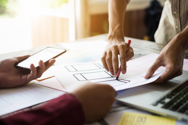 istock Web designers concept. Man brainstorming for ideas and sketching at meeting room. 954542708
