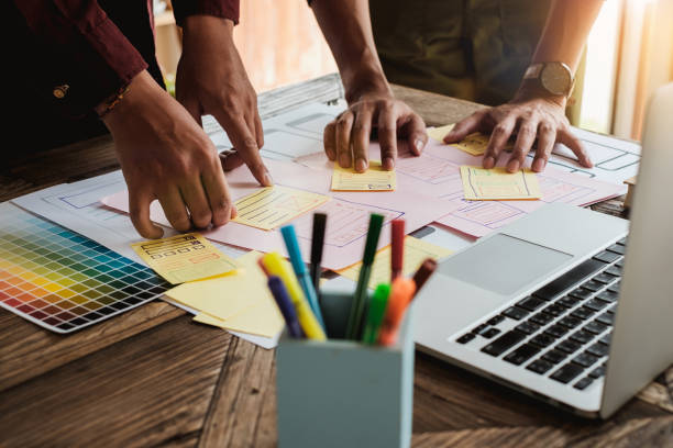 istock Web designers concept. Man brainstorming for ideas and sketching at meeting room. 954543854