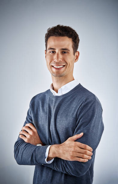 istock Handsome young man smiles contentedly 954545650