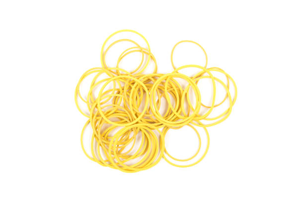 istock Pile of yellow rubber bands isolated on white background. Packaging supplies and accessory. Thin rubber bands. 954545880