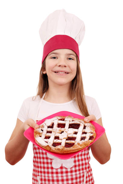istock happy little girl cook with cherry pie on plate 954548342