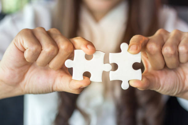 istock Businessman hands connecting jigsaw puzzle. Business solutions, success and strategy, learning concept. 954548724