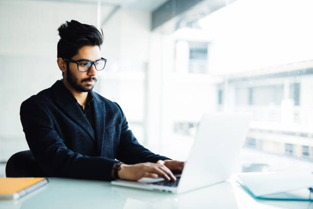 istock Young handsome indian male working at office 954552036