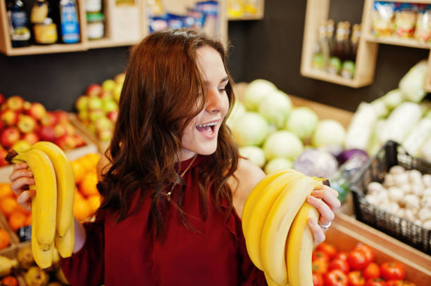 istock Girl in fruits store 954552258