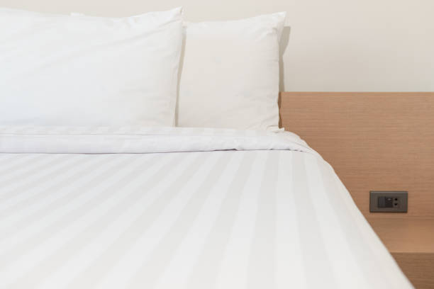 istock White pillow and white bed in bed room 954553070