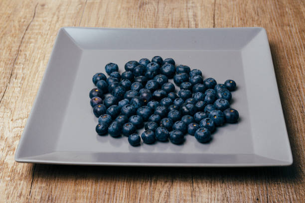 istock large, fresh blueberries lie on a gray plate, close-up 954553980
