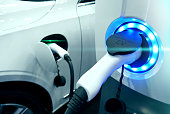 Power supply connect to electric vehicle for charge to the battery. Charging technology industry transport which are the futuristic of the Automobile. EV fuel Plug in hybrid car.