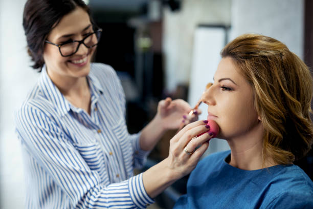 istock Female make up artist working on model in salon 954565040