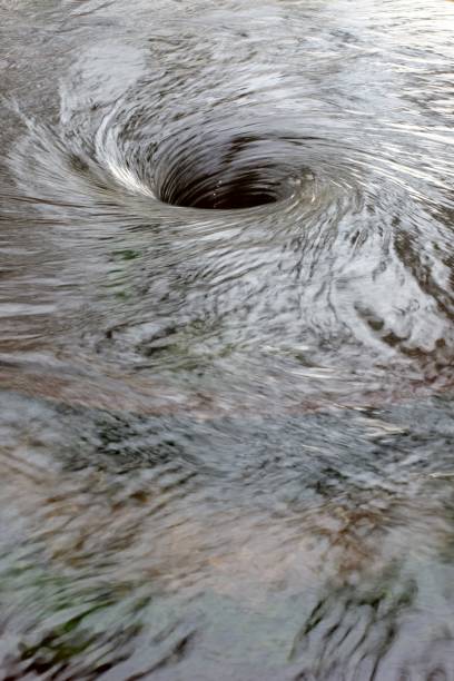 Berkshire, England - March 11, 2018: the rapid movement of water is captured in this image of a small whirlpool.
