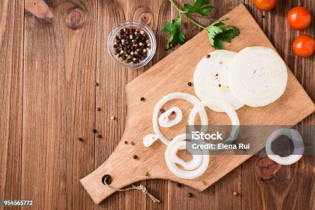 Onion Rings On A Cutting Board On A Wooden Table Stock Photo - Download Image Now - Onion, Cutting, Directly Above