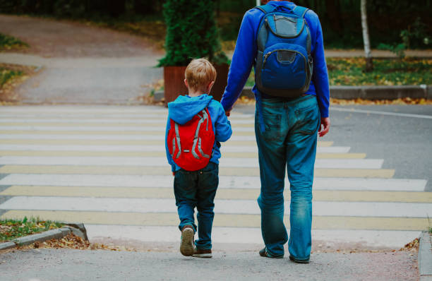 istock father and son go to school, education 954570200