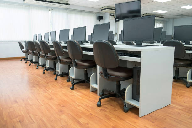 istock Row of Computers On Desks In Classroom at General Training Center 954570366