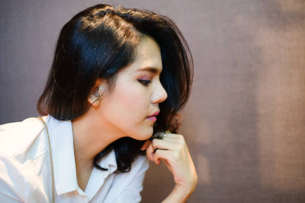 istock young beautiful asian woman close up side portrait with copy space.selective focus image. 954570780