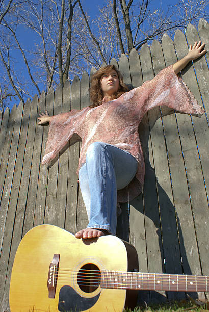 Girl Stands on Her Guitar stock photo