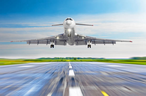 istock Large passenger plane take off from the runway before the light from the sunshine. 954572526