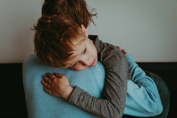 Father comforting sad child, parenting, sorrow Father comforting sad child, parenting, sorrow, stress child sadness stock pictures, royalty-free photos & images