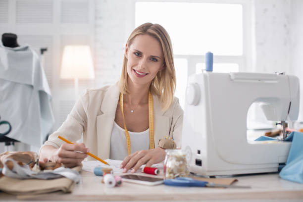 istock Happy female couturier sketching 954583310