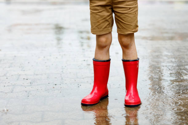 Child Wearing Red Rain Boots Jumping 