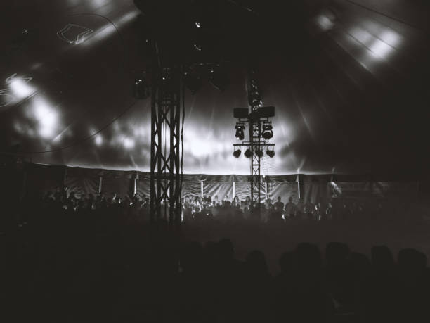 Monochrome atmospheric circus scene with large audience