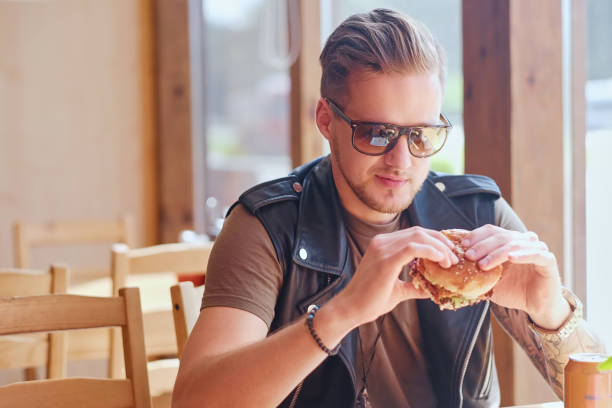 istock A man eating a vegan burger. 954587958