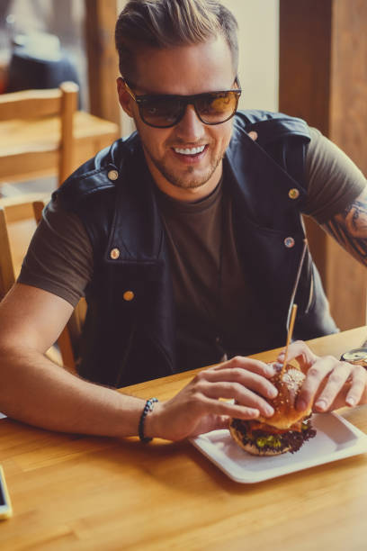 istock A man eating a vegan burger. 954591066