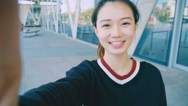 istock young woman smile take selfie 954591238