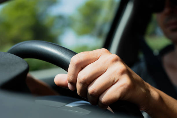 istock young caucasian man driving a car 954591308