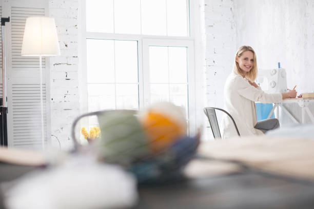 istock Joyful female couturier designing garment 954591914