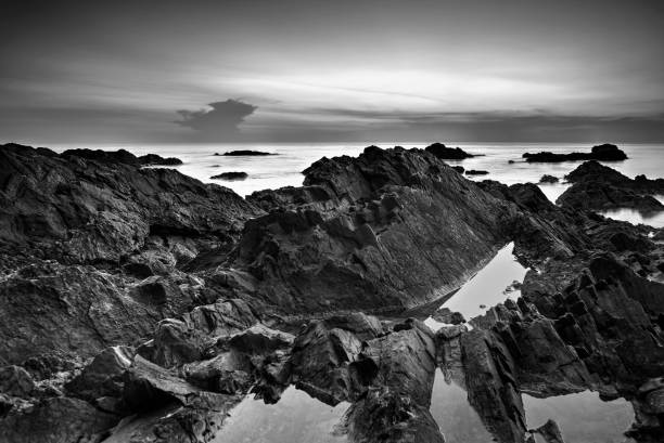 istock Rock Formations In Sea Against Sky 954597318
