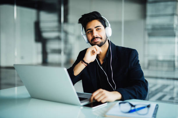 istock Young businessman working with laptop computer and headphone in the office 954606058