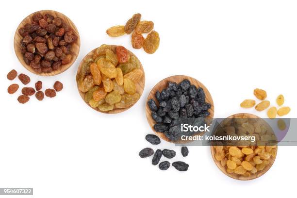 Collection Of Raisins In Wooden Bowl Isolated On A White Background With Copy Space For Your Text Top View Flat Lay Stock Photo - Download Image Now