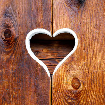 Wooden fence with heart. Part of a window in Tirol, Austria.