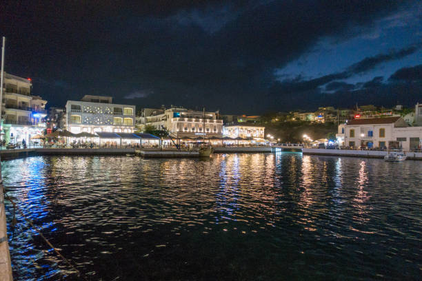 istock Sea and illuminated buildings at night 954609880