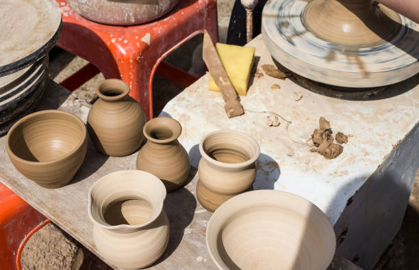 istock Potter busy making a pot. Potter works with clay by hands. 954616932