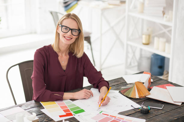 istock Positive female designer filling up form 954616952