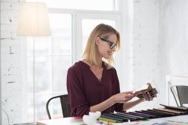 istock Jolly female designer selecting upholstery 954620528