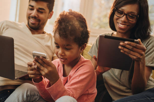 istock Happy African American family using wireless technology at home. 954621450