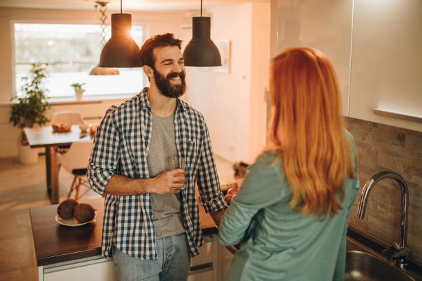 istock Happy couple communicating while spending their time in the kitchen. 954622428
