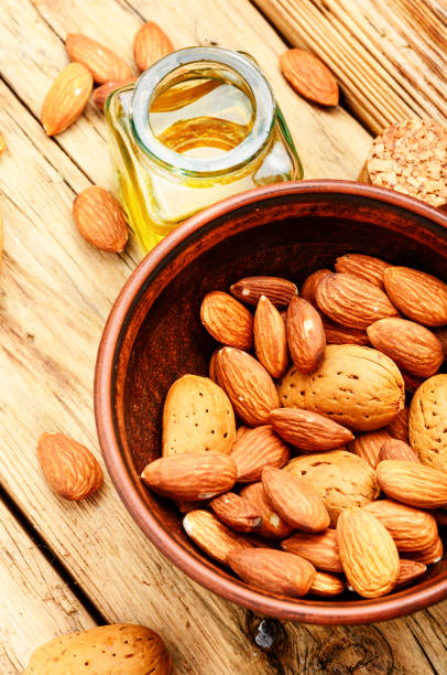 istock Almond oil in bottle and nuts 954625544