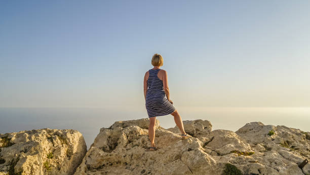 istock Middle-aged woman looks into distance 954633852