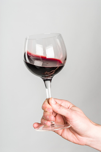 Glass of wine held by hand.