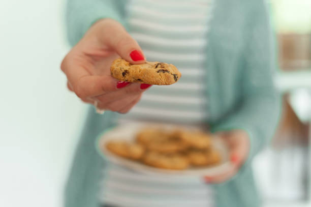 istock Woman holding plate with home made cookies 954635816
