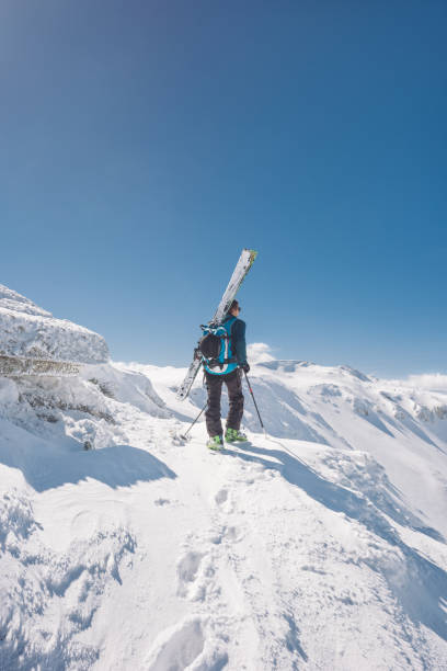 istock Male skier looking at view on the mountain 954641026
