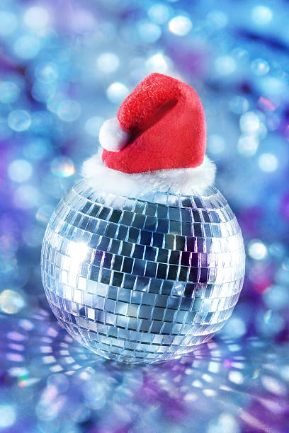 Shiny disco ball in santa hat stock photo