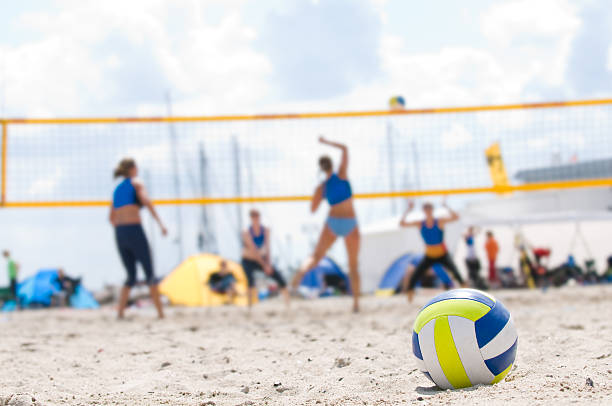 Beach Volleyball with closeup of ball in foreground stock photo
