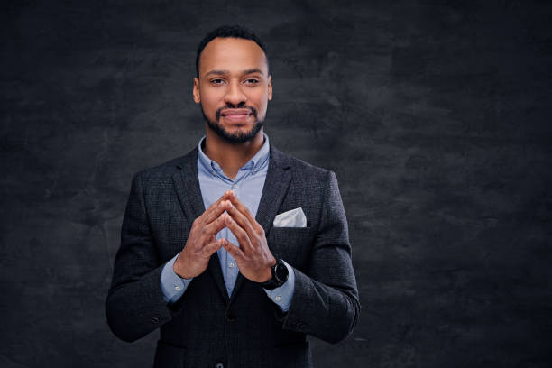 istock A stylish black male dressed in a suit over grey background. 954650316