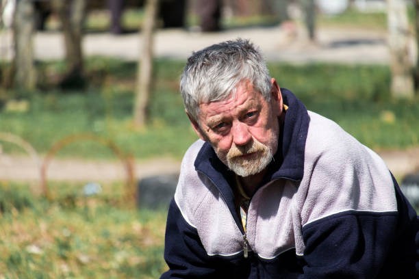 Sighisoara/Romania; 06/30/2018. Elderly man Caucasian ethnicity sitting on a bench passing time.