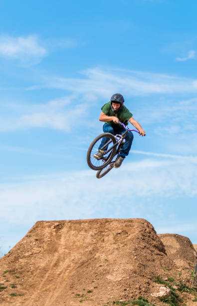 istock Young man flying on dirtjump bike 954655200